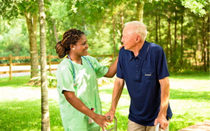 Fall Prevention Care New Port Richey, FL Caregiver helping elderly man with walker