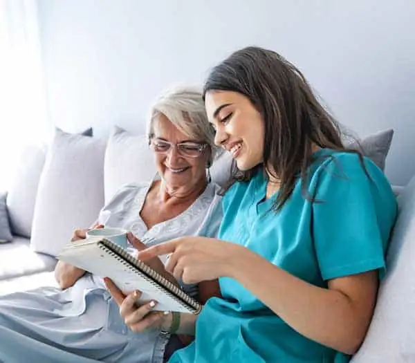 Homemaking Services Caregiver assisting elderly woman